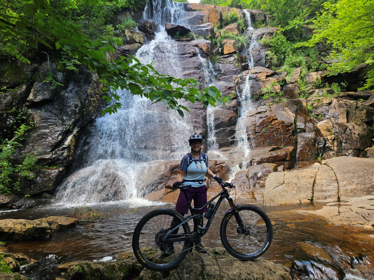 author in front of waterfall