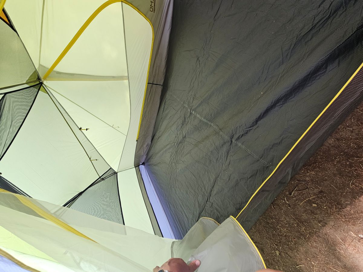 view of the inside of the tent from outside, empty