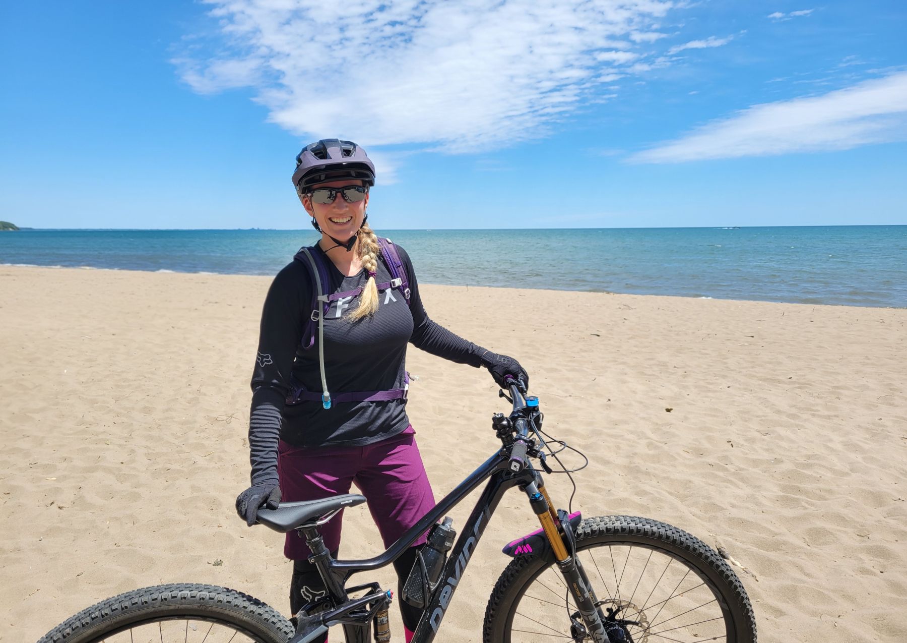 Jenny on the beach with her mountain bike